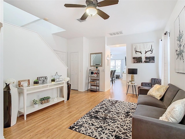 living room featuring ceiling fan and wood-type flooring