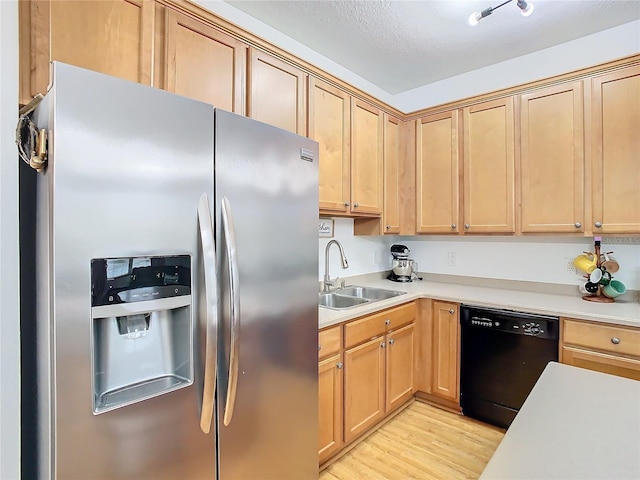 kitchen featuring sink, stainless steel refrigerator with ice dispenser, light wood-type flooring, a textured ceiling, and black dishwasher