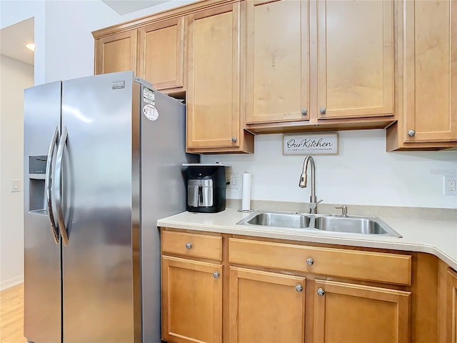 kitchen with stainless steel fridge with ice dispenser, light hardwood / wood-style flooring, and sink