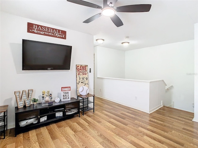 living room with ceiling fan and light wood-type flooring