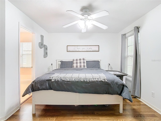 bedroom featuring hardwood / wood-style flooring, ceiling fan, and ensuite bathroom