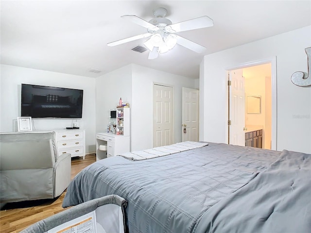 bedroom with hardwood / wood-style flooring, ceiling fan, and ensuite bathroom