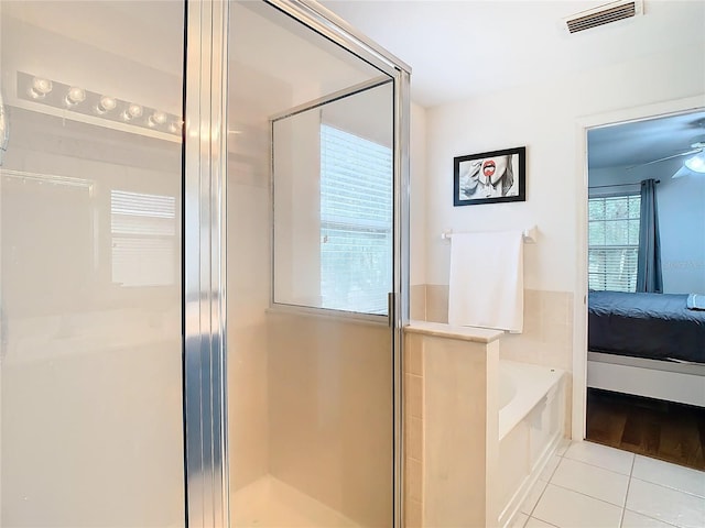 bathroom with tile patterned floors and independent shower and bath