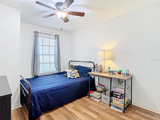 bedroom with ceiling fan and wood-type flooring