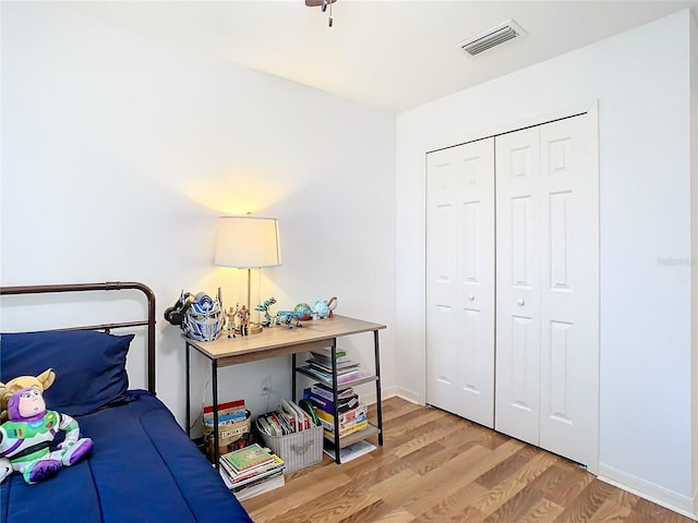 bedroom with a closet and light hardwood / wood-style floors