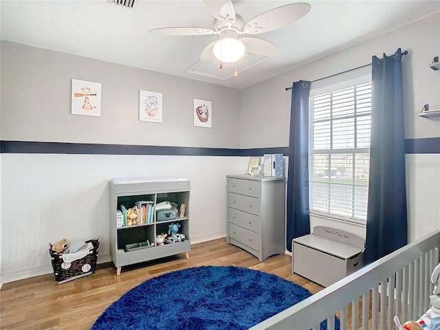 bedroom with ceiling fan and light hardwood / wood-style floors