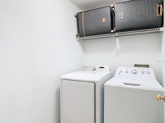 laundry area with separate washer and dryer