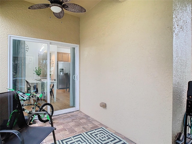 view of exterior entry with ceiling fan