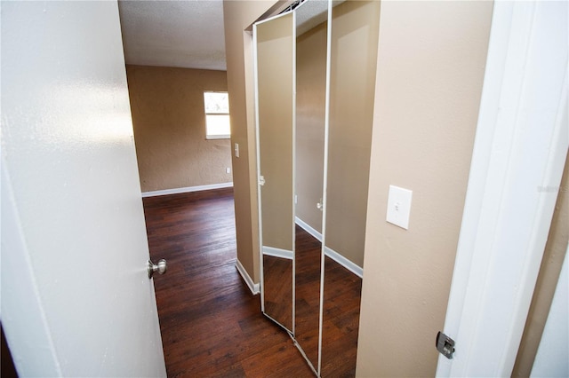 hallway with dark wood-type flooring