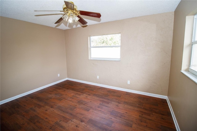 unfurnished room featuring dark hardwood / wood-style floors and ceiling fan