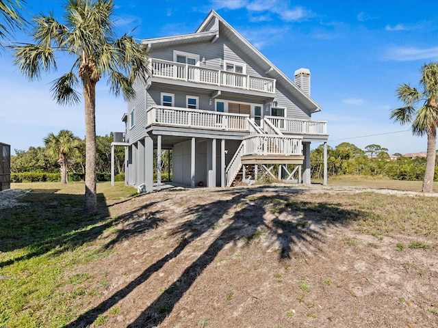 back of house featuring a carport and a balcony