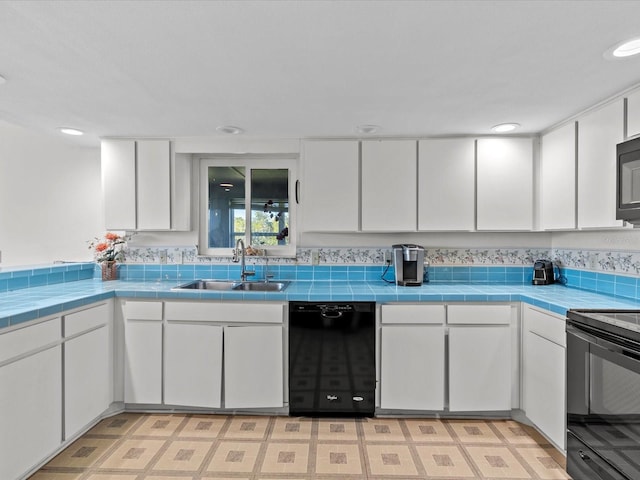 kitchen with white cabinets and black appliances