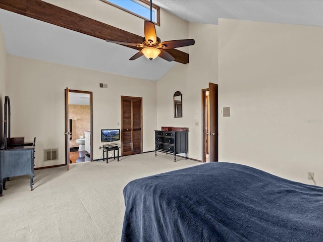 carpeted bedroom with ceiling fan, high vaulted ceiling, and ensuite bath