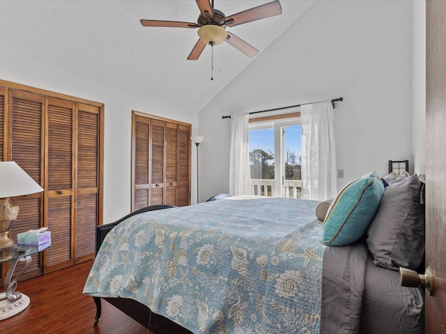 bedroom featuring multiple closets, ceiling fan, high vaulted ceiling, hardwood / wood-style floors, and a textured ceiling