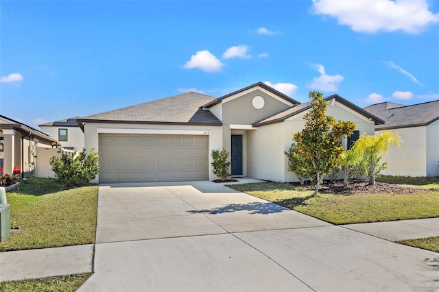 view of front of home featuring a front yard and a garage