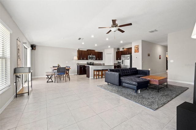 living room with light tile patterned floors and ceiling fan