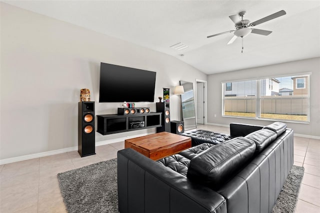 living room with ceiling fan, light tile patterned floors, and vaulted ceiling