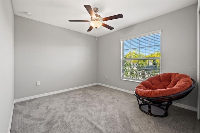 living area with ceiling fan and carpet floors