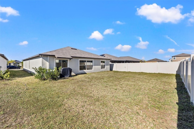 rear view of house with a yard