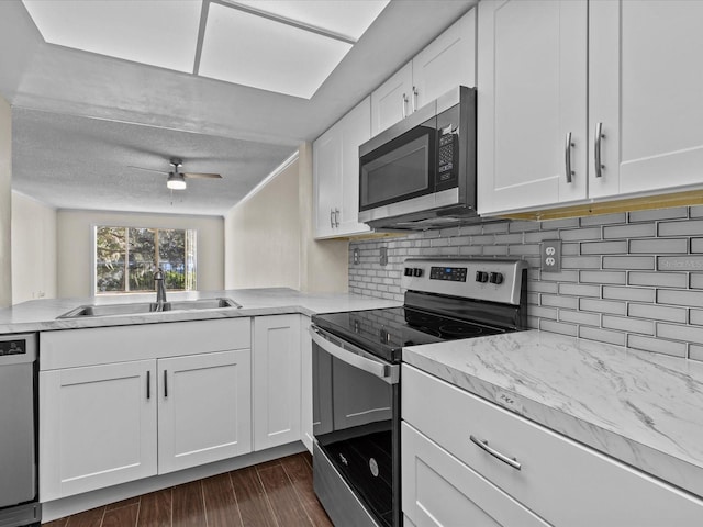 kitchen with white cabinets, ceiling fan, sink, and appliances with stainless steel finishes