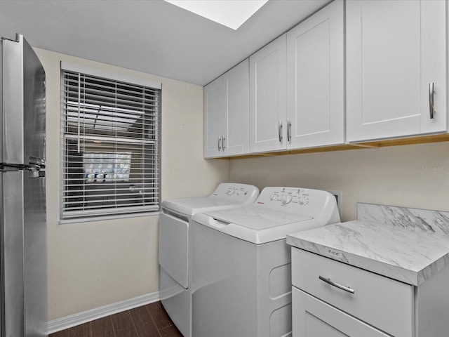 laundry area featuring cabinets, dark wood-type flooring, and washing machine and dryer