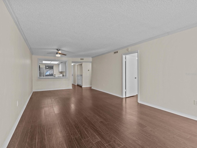 unfurnished living room with a textured ceiling, ceiling fan, dark hardwood / wood-style floors, and ornamental molding