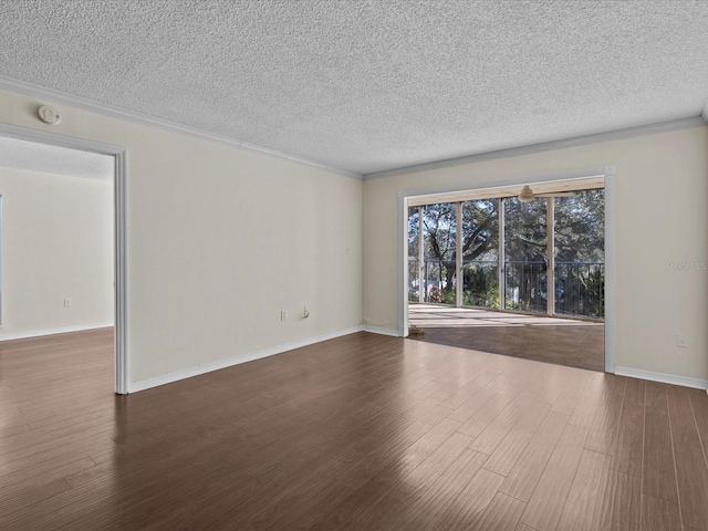 empty room with crown molding, dark hardwood / wood-style flooring, and a textured ceiling