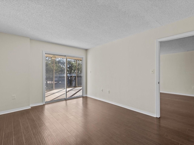 unfurnished room with a textured ceiling and dark hardwood / wood-style floors