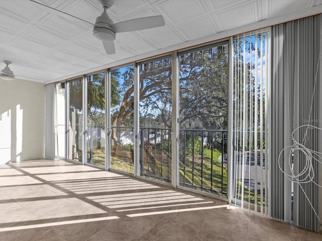 unfurnished sunroom with ceiling fan