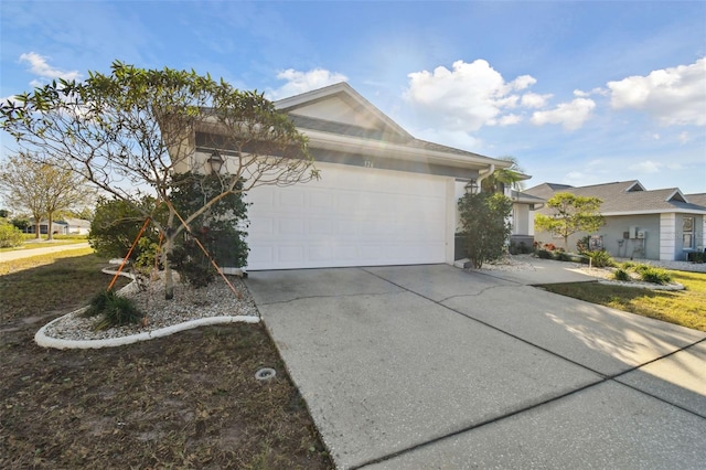 single story home with a garage and concrete driveway