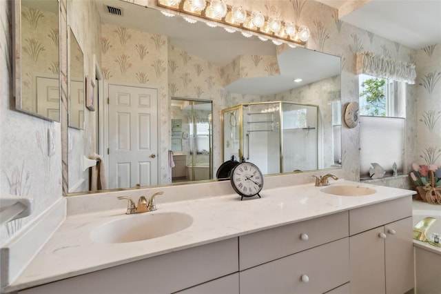 bathroom with a shower stall, a sink, visible vents, and wallpapered walls