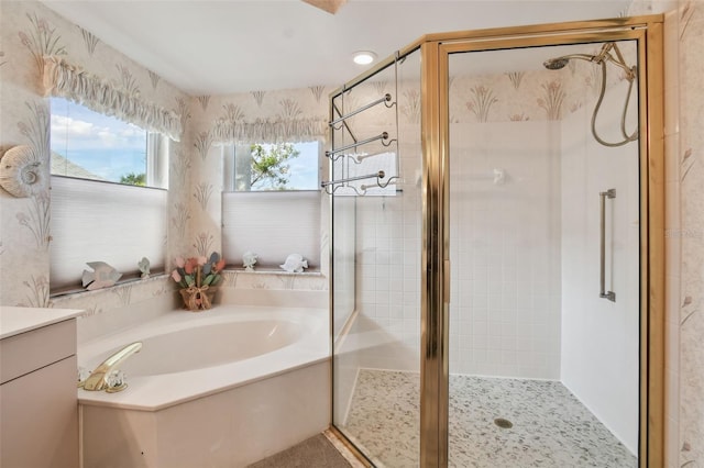 full bath featuring a stall shower, a garden tub, and vanity