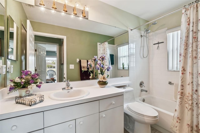 bathroom featuring vanity, shower / bath combo with shower curtain, and toilet