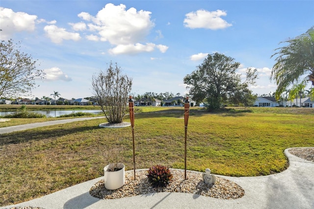 view of yard featuring a residential view and a water view