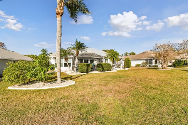 exterior space with a lanai and a yard