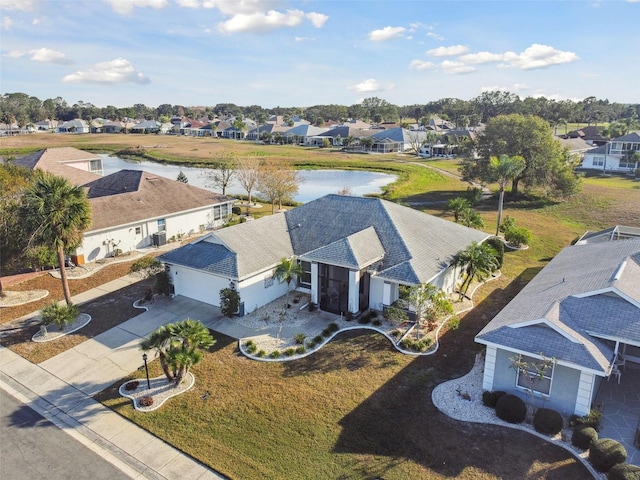 bird's eye view featuring a residential view and a water view