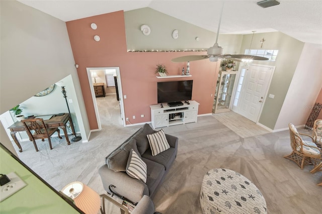 living room featuring visible vents, high vaulted ceiling, baseboards, and light colored carpet