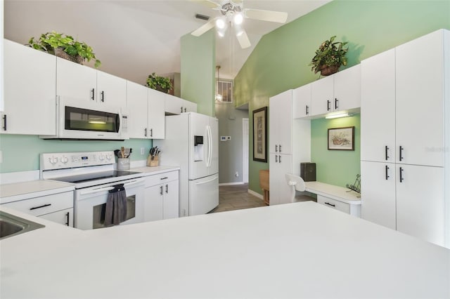 kitchen featuring white appliances, white cabinetry, and light countertops