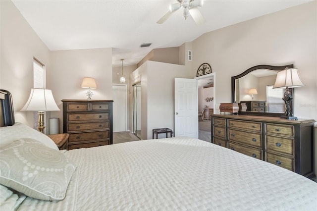 bedroom featuring lofted ceiling, ceiling fan, a closet, and visible vents