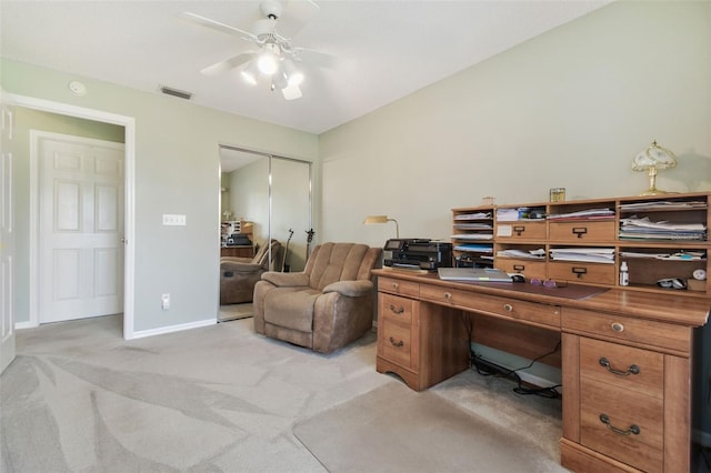 office featuring a ceiling fan, light colored carpet, visible vents, and baseboards