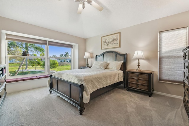 bedroom with light carpet, ceiling fan, baseboards, and a textured ceiling