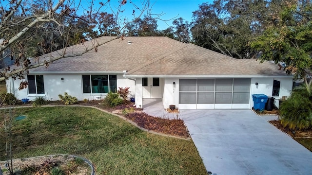 single story home featuring a garage and a front lawn