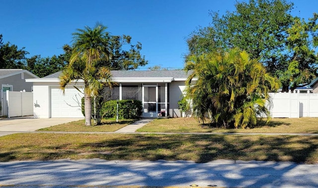 view of front of home with a garage and a front lawn