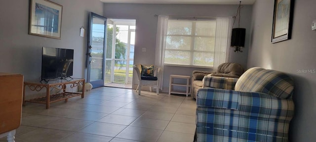 living area with a healthy amount of sunlight and light tile patterned floors