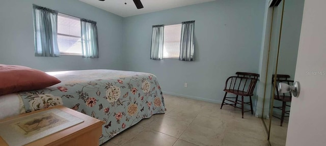 bedroom with light tile patterned floors and ceiling fan