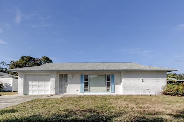 single story home featuring a front yard and a garage