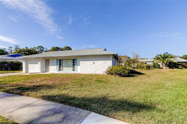 view of front of property with a front yard and a garage