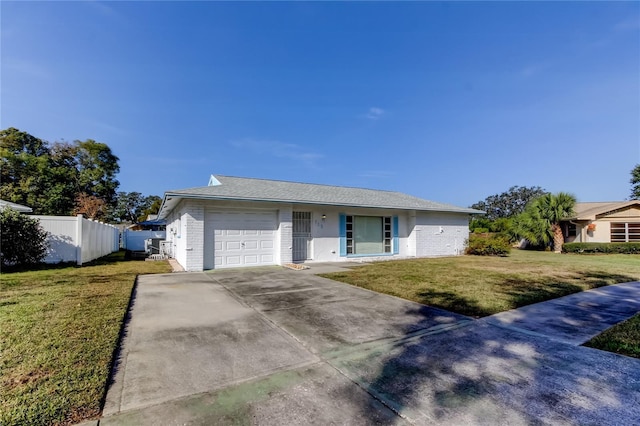 single story home featuring a front lawn and a garage