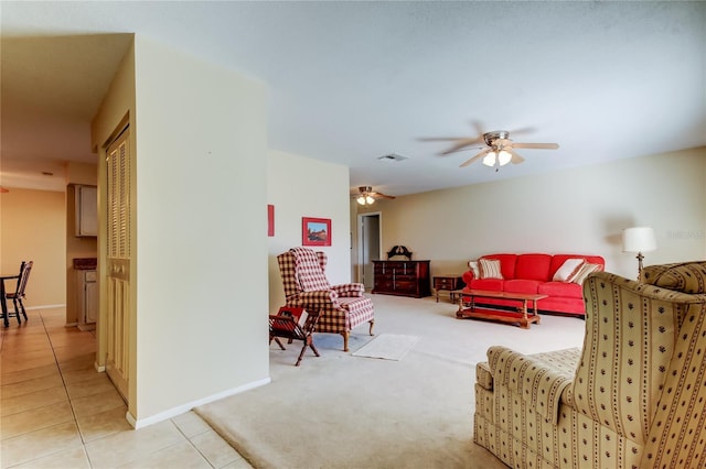 tiled living room featuring ceiling fan