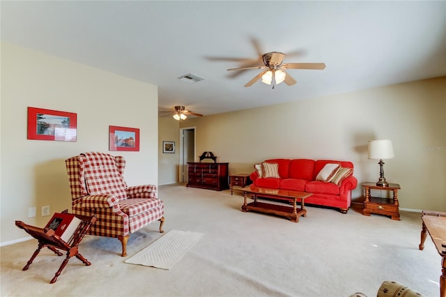 carpeted living room with ceiling fan